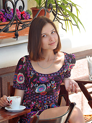 Delicious dark haired sweetie undressing and posing naked outdoor on the chair in the park.